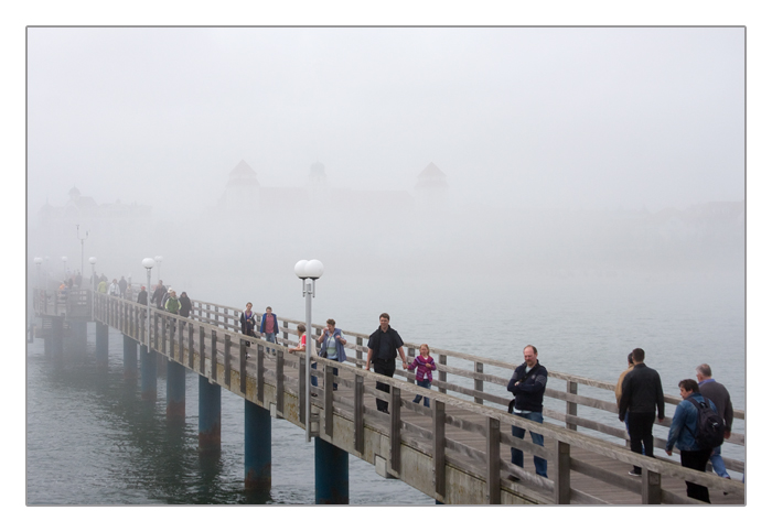 Seebrücke im Nebel mit kurzzeitigem Blick auf das Kurhaus Binz